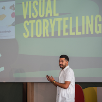 Man presenting with big screen on his back